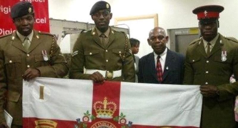 Boys of British Army standing beside a veteran who served in the Warwickshire’s
